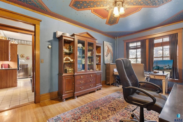 home office with crown molding, light wood-type flooring, and ceiling fan