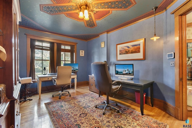 office with crown molding, vaulted ceiling, light wood-type flooring, and ceiling fan