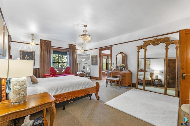 bedroom featuring a notable chandelier and carpet floors