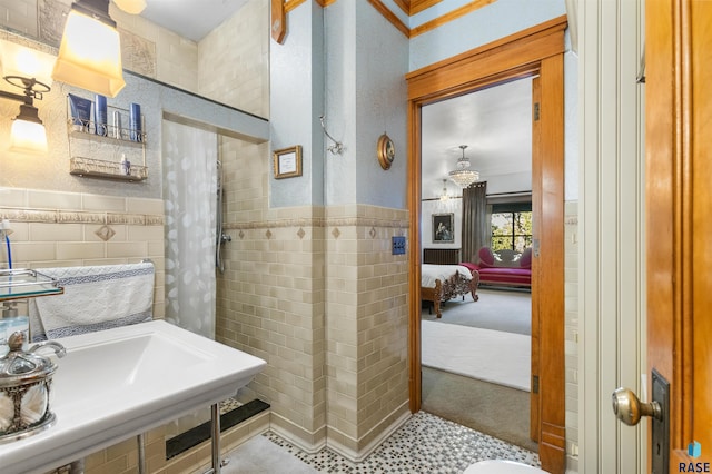 bathroom featuring sink and tile walls