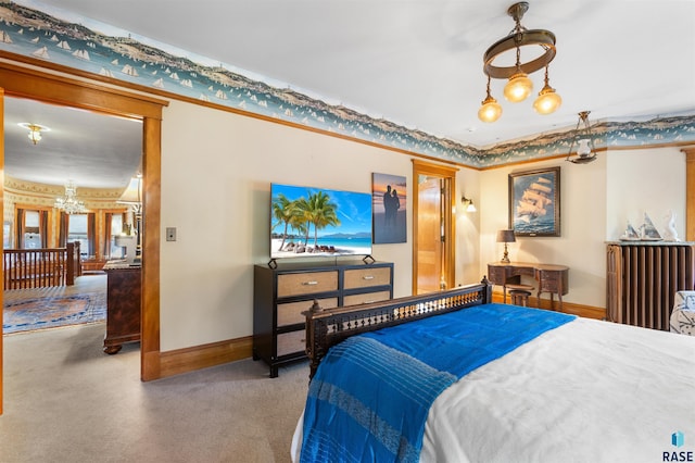 carpeted bedroom featuring an inviting chandelier