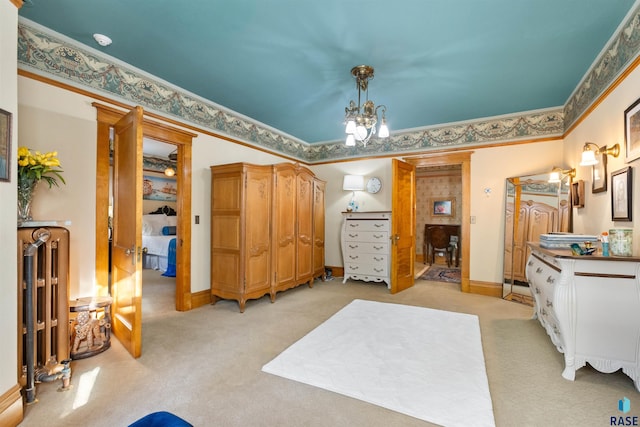 bedroom featuring crown molding, radiator heating unit, a chandelier, and light colored carpet