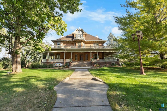 view of front of property with covered porch and a front yard