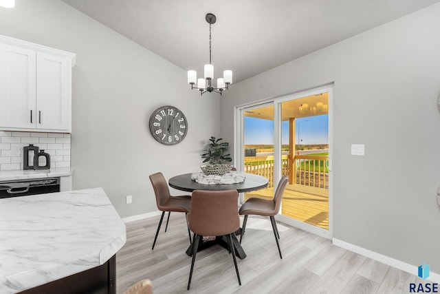 dining room featuring light hardwood / wood-style flooring and a notable chandelier