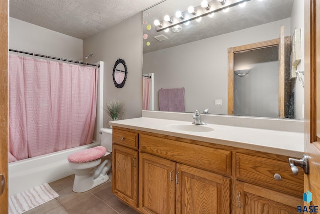 full bathroom with shower / tub combo, a textured ceiling, toilet, vanity, and tile patterned floors