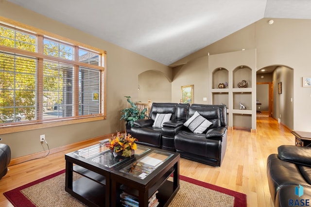 living room featuring vaulted ceiling and hardwood / wood-style flooring