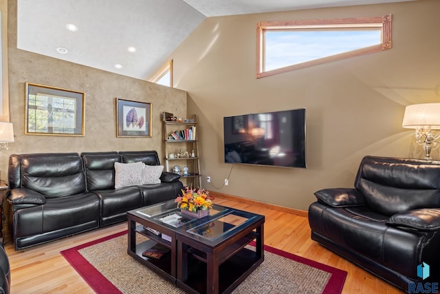 living room featuring hardwood / wood-style flooring and high vaulted ceiling