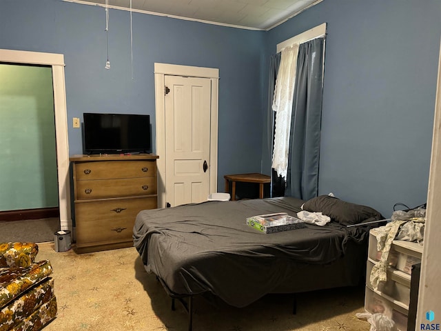 carpeted bedroom featuring crown molding