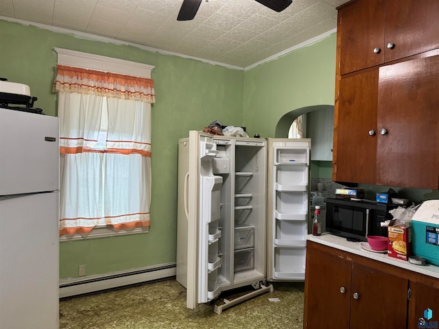 kitchen featuring ornamental molding, ceiling fan, baseboard heating, and white refrigerator