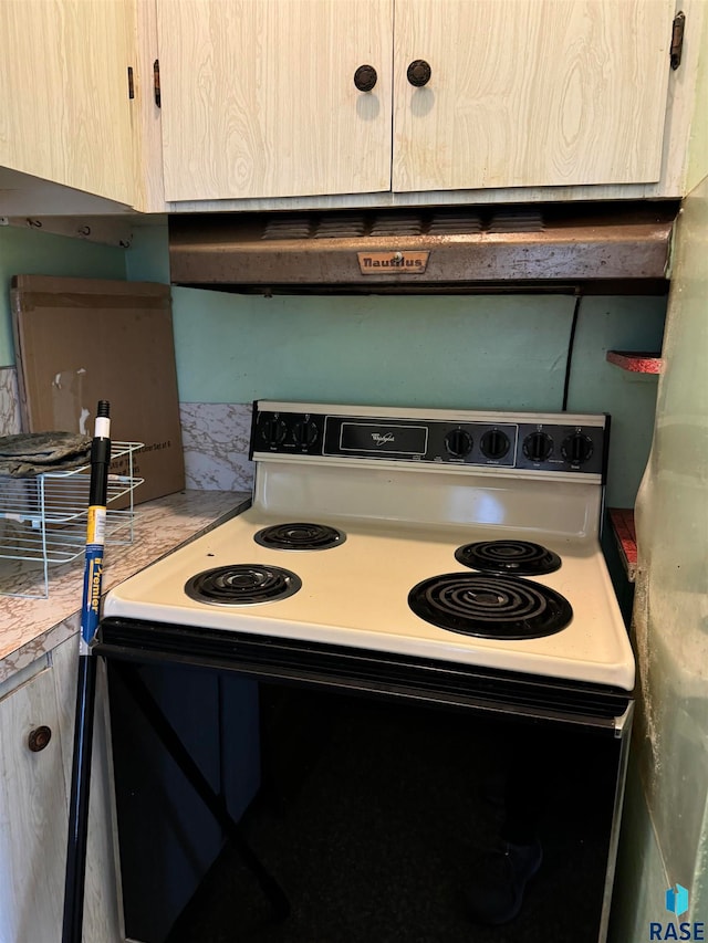 kitchen with light brown cabinetry and white range with electric cooktop