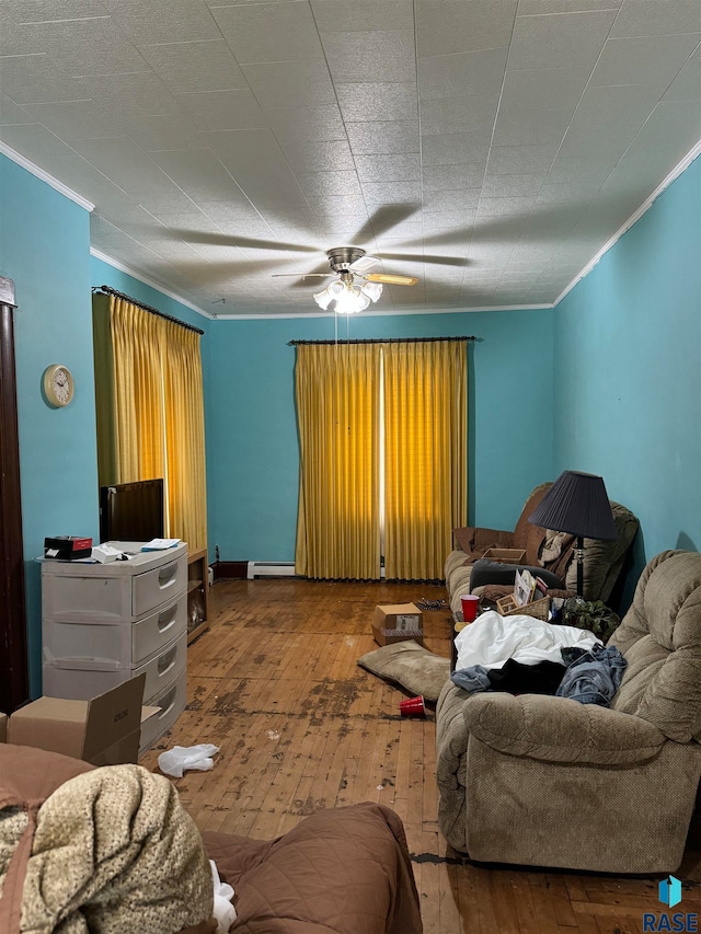 living room with ceiling fan, crown molding, a baseboard heating unit, and hardwood / wood-style floors