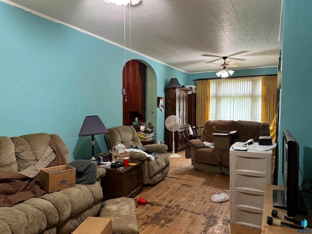 living room featuring ceiling fan, hardwood / wood-style flooring, and a textured ceiling