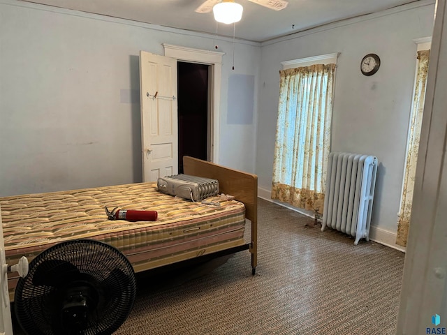 bedroom with ornamental molding, multiple windows, radiator heating unit, and ceiling fan