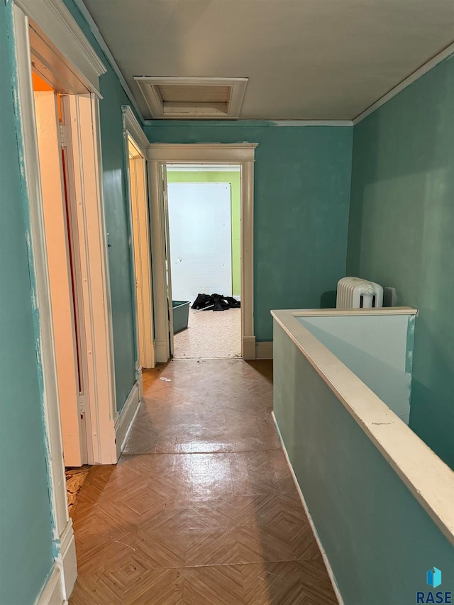 corridor featuring ornamental molding, light parquet flooring, and radiator heating unit