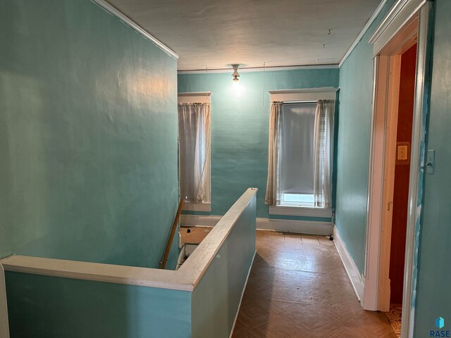 hall featuring crown molding and parquet floors