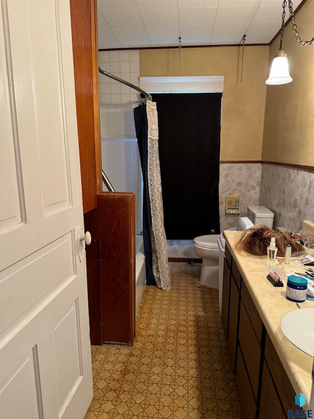 full bathroom with vanity, shower / bath combo, and toilet