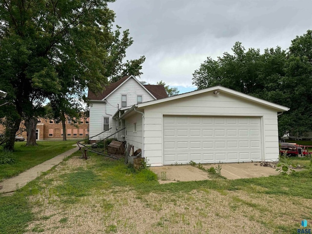 exterior space with a yard and a garage