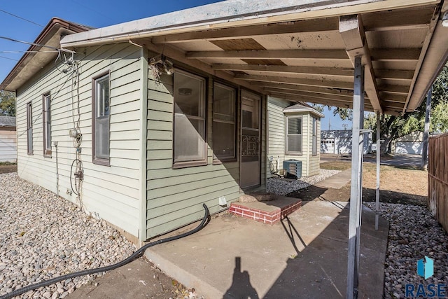 view of side of home featuring cooling unit