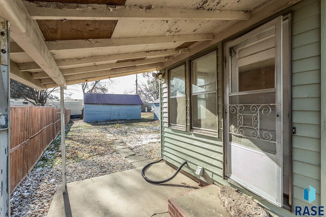 view of patio featuring a storage unit