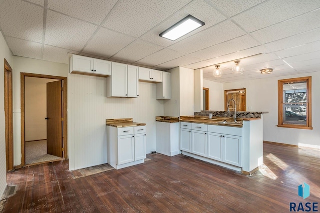 kitchen featuring white cabinetry, dark hardwood / wood-style flooring, and wood counters