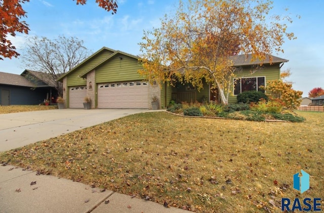 ranch-style house featuring a front yard and a garage