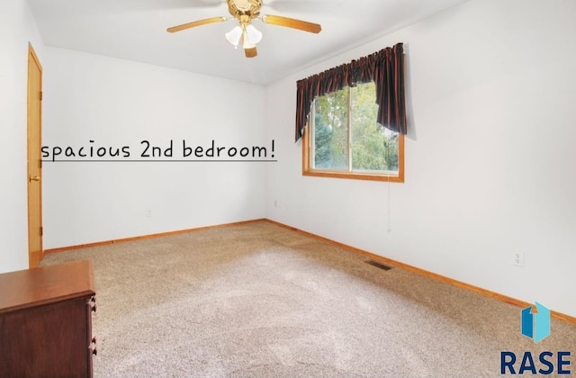 carpeted empty room with ceiling fan