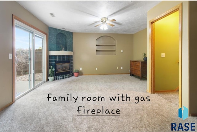 carpeted living room featuring ceiling fan, a textured ceiling, and a fireplace