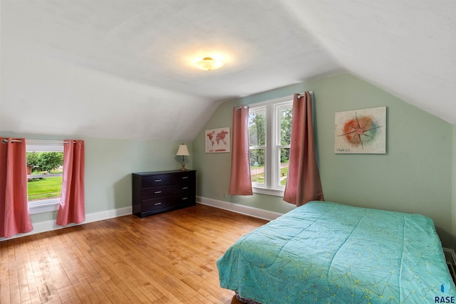 bedroom featuring light wood-type flooring and lofted ceiling