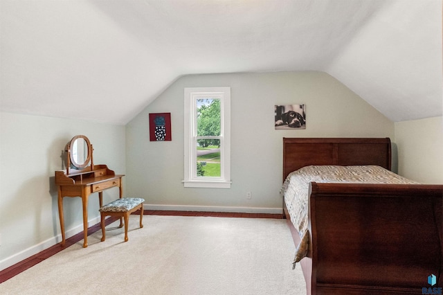 bedroom featuring lofted ceiling and hardwood / wood-style flooring