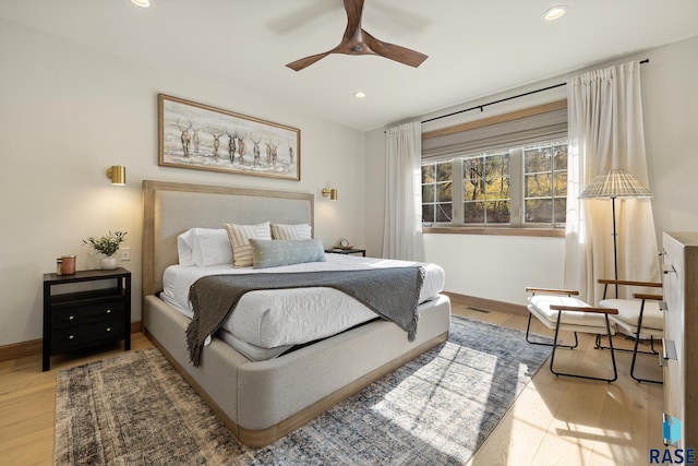 bedroom featuring light hardwood / wood-style flooring and ceiling fan