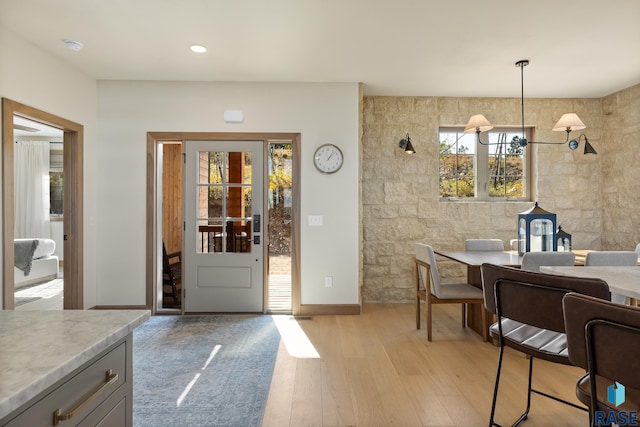 dining area featuring light hardwood / wood-style flooring and tile walls