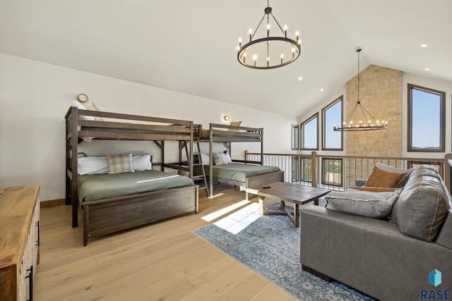 interior space featuring lofted ceiling, a notable chandelier, and light wood-type flooring