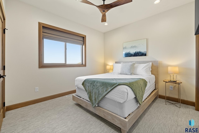 bedroom featuring light colored carpet and ceiling fan