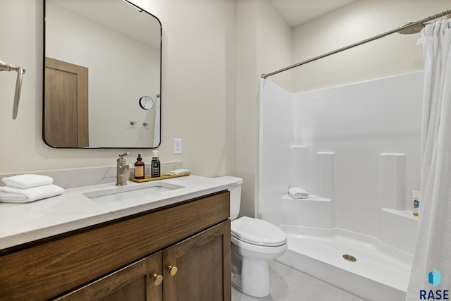 bathroom featuring toilet, vanity, and a shower with shower curtain