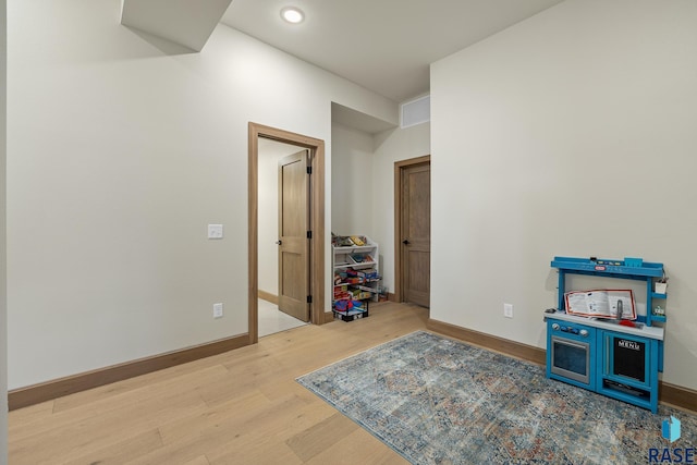 recreation room with hardwood / wood-style flooring