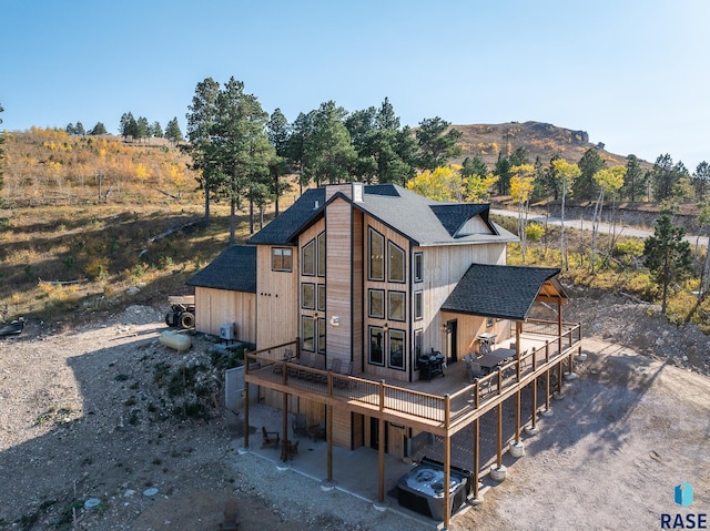 rear view of house featuring a deck with mountain view