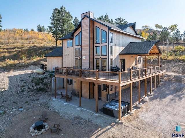 rear view of property featuring a deck