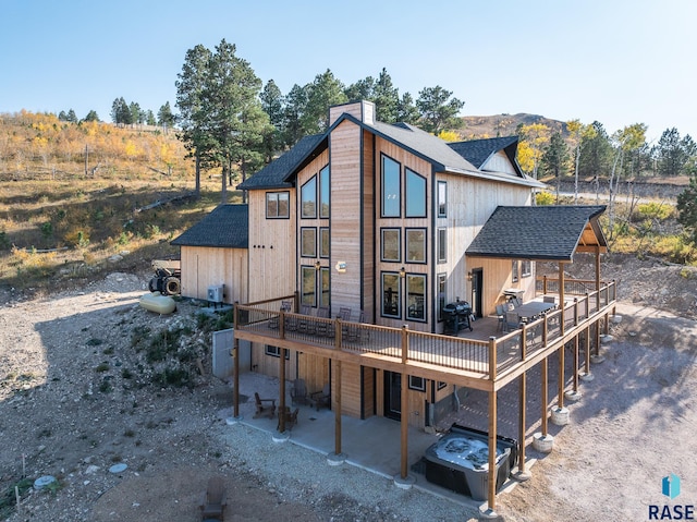 back of house featuring a deck with mountain view