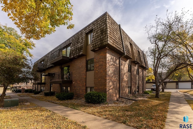 view of home's exterior with a balcony and a garage