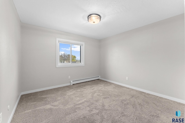 empty room with a textured ceiling, carpet floors, and baseboard heating