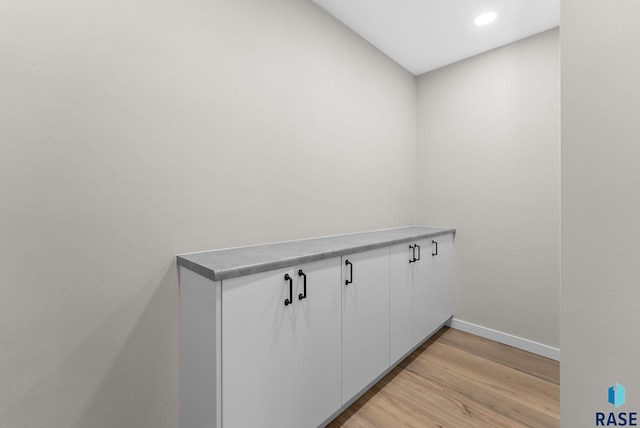 laundry area with light hardwood / wood-style flooring