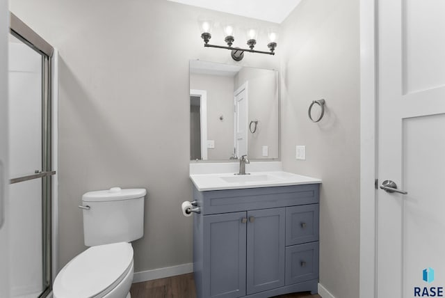 bathroom with vanity, toilet, and wood-type flooring