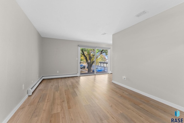 empty room with light hardwood / wood-style flooring