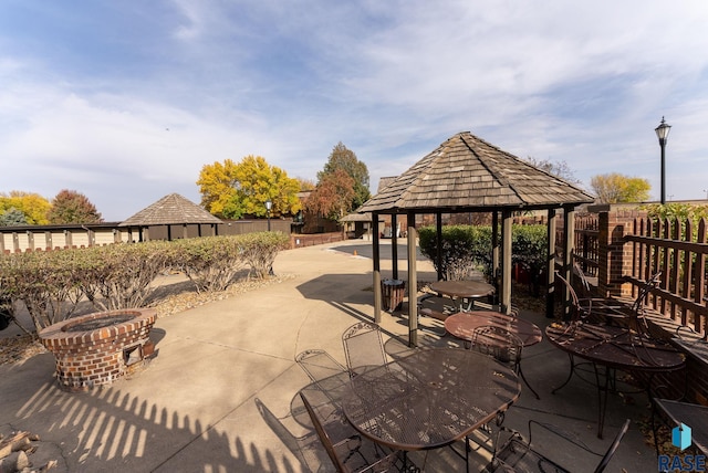 exterior space featuring a gazebo and a fire pit