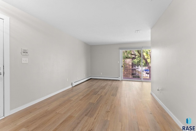 spare room featuring light hardwood / wood-style flooring and a baseboard radiator