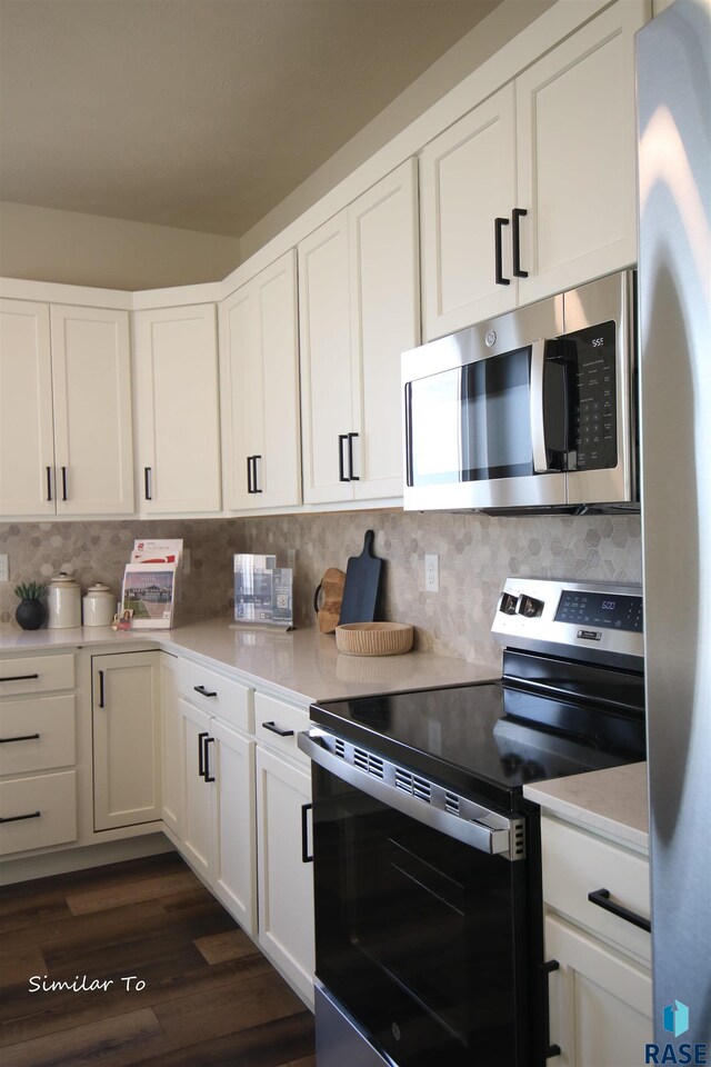 kitchen featuring decorative backsplash, white cabinetry, and stainless steel appliances