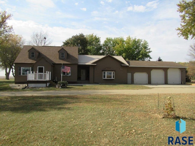 view of front of home with a front lawn and a garage