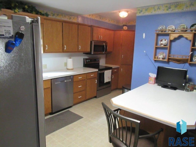 kitchen with appliances with stainless steel finishes, a kitchen bar, and kitchen peninsula