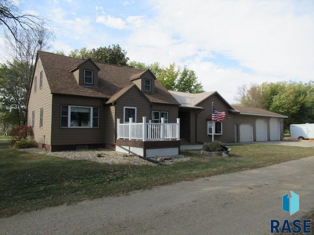 cape cod home with a front lawn and a garage