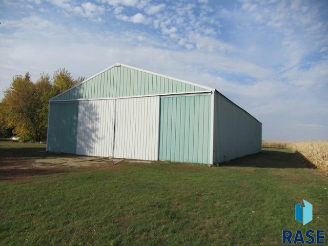 view of outbuilding with a lawn